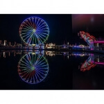 Ein Riesenrad in Luzern spiegelt sich in einem Gewässer.